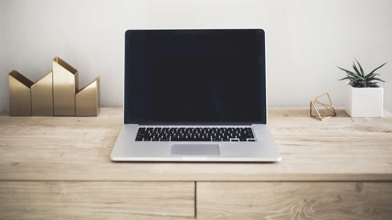 A laptop on a wooden table