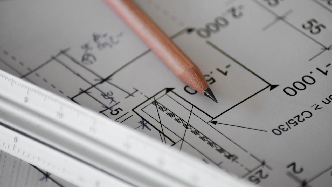 Pencil resting on a printed building plan