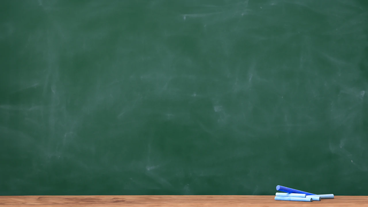 Chalk on the ledge of a green chalkboard