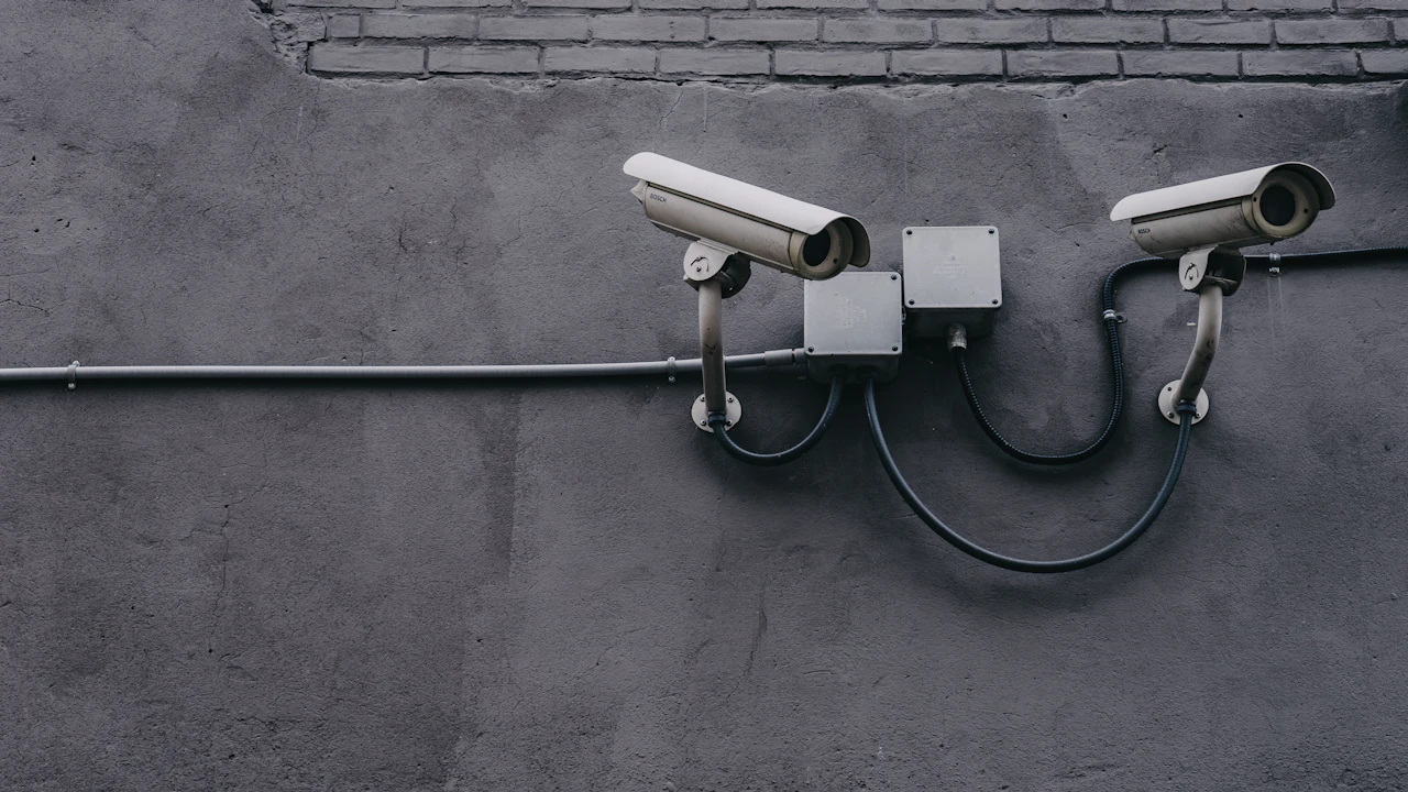 Two cameras mounted on a wall