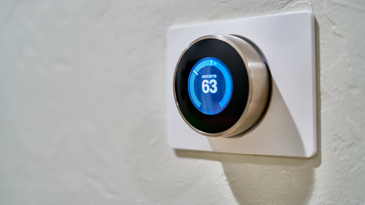 A smart thermostat on a wall