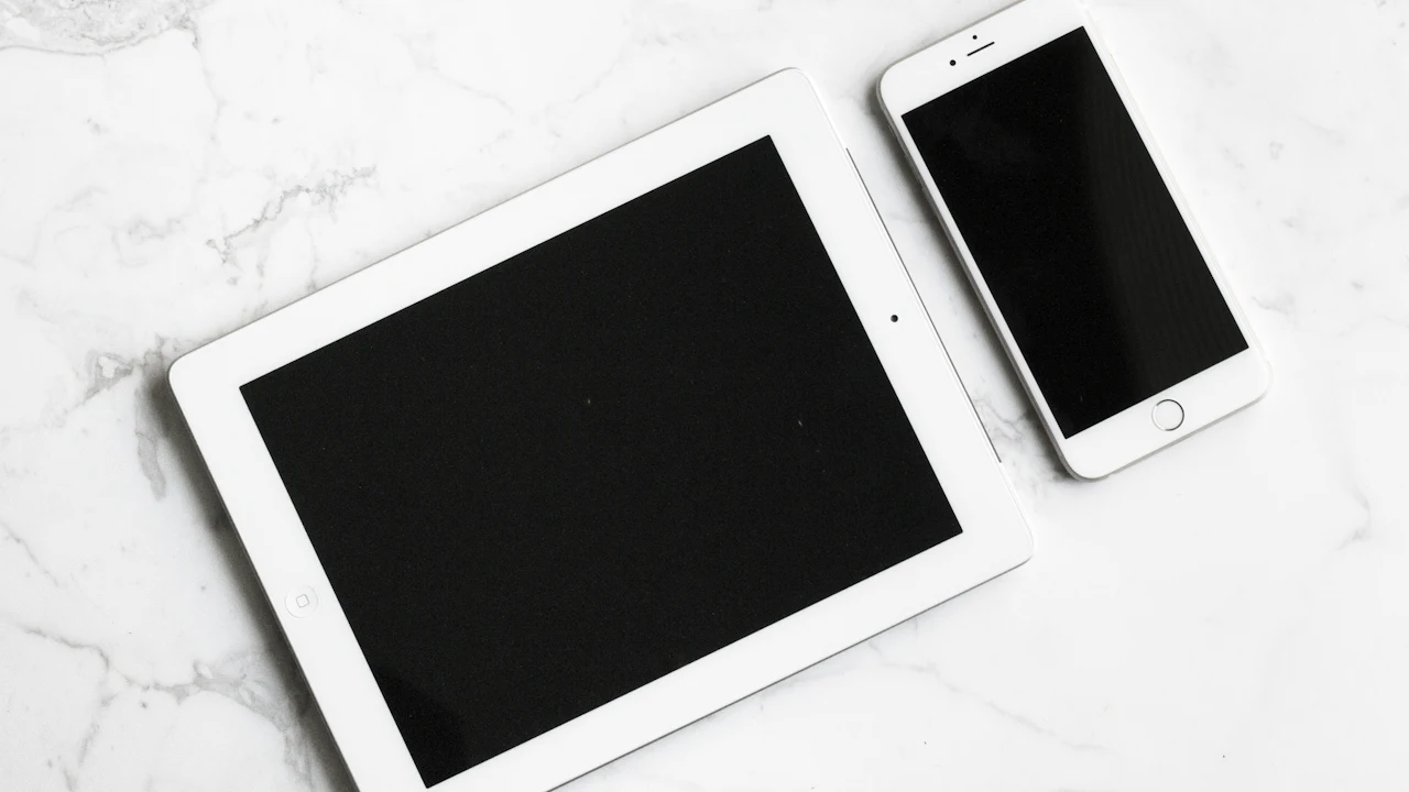 A tablet and a phone on a desk